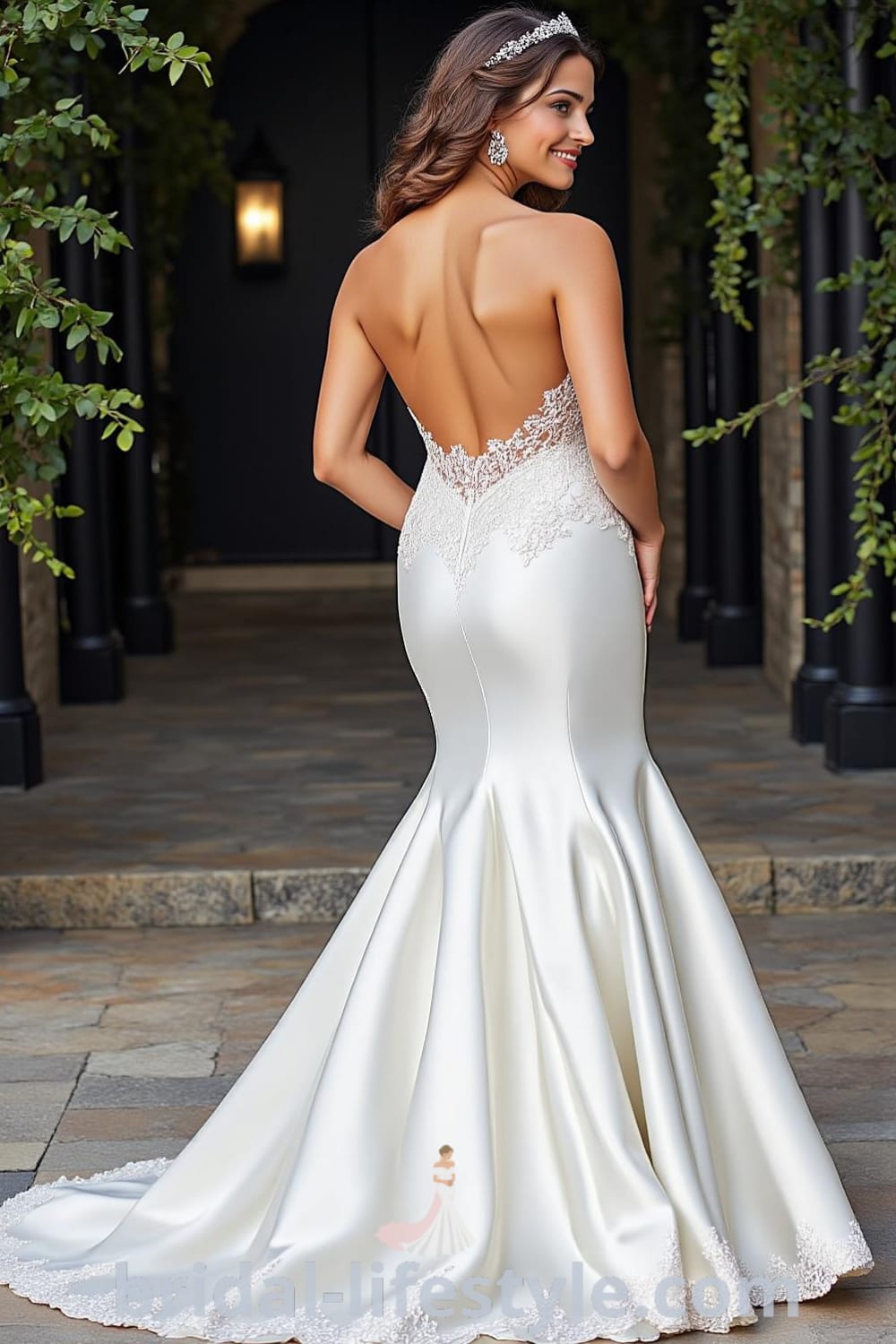 Strapless mermaid wedding dress made of luxurious satin with lace overlay and floral patterns, featuring a fishtail skirt and dramatic train. bridal-lifestyle.com