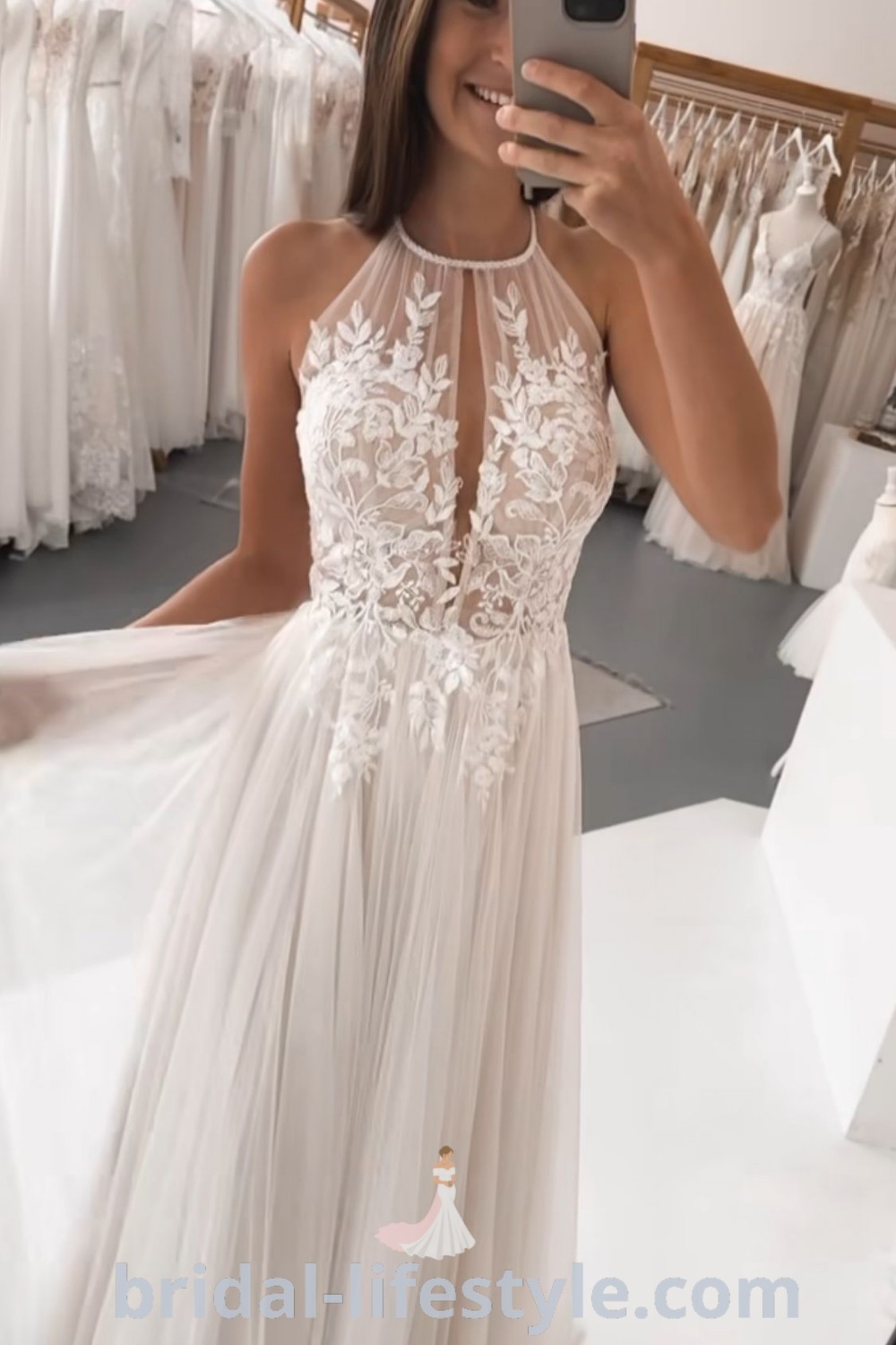 An elegant Summer Satin Wedding Dress in a bridal shop, showcasing a woman taking a selfie. The halter style is perfect for small busts and embodies the aesthetic ideas of simple rustic wedding dresses. A must-see for every bride