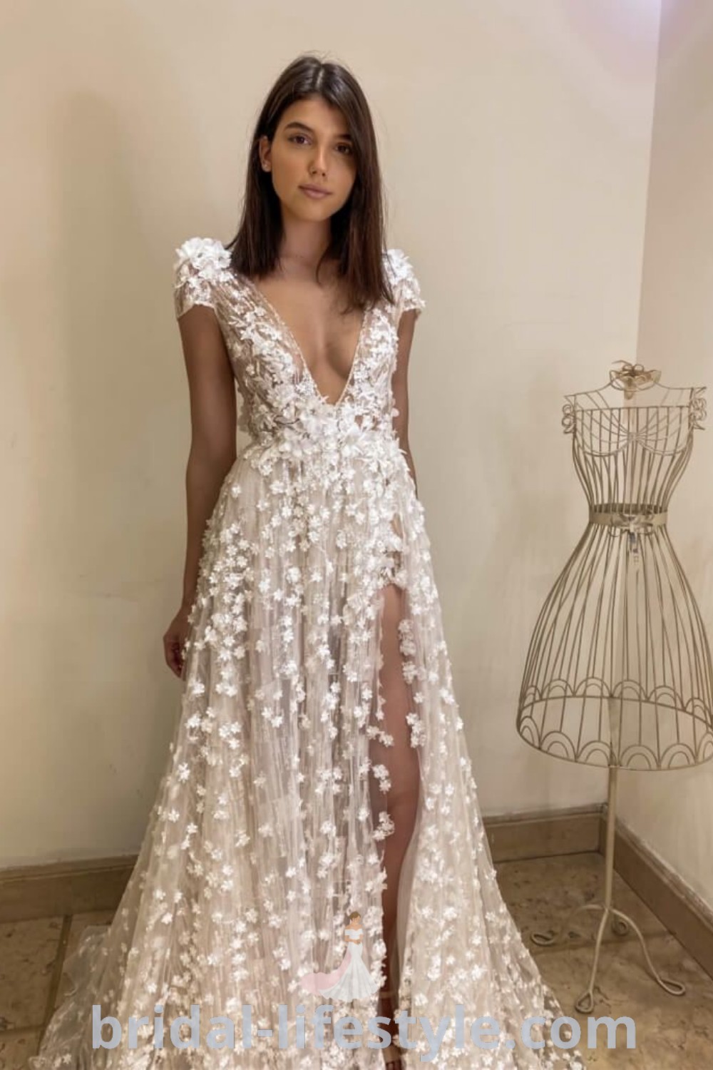 A woman wearing a white dress with floral patterns, embodying shabby chic and boho chic wedding dress aesthetics. This elegant wedding ensemble is perfect for dreamy brides, ensuring a stunning presence on the special day, featured at bridal-lifestyle.com.