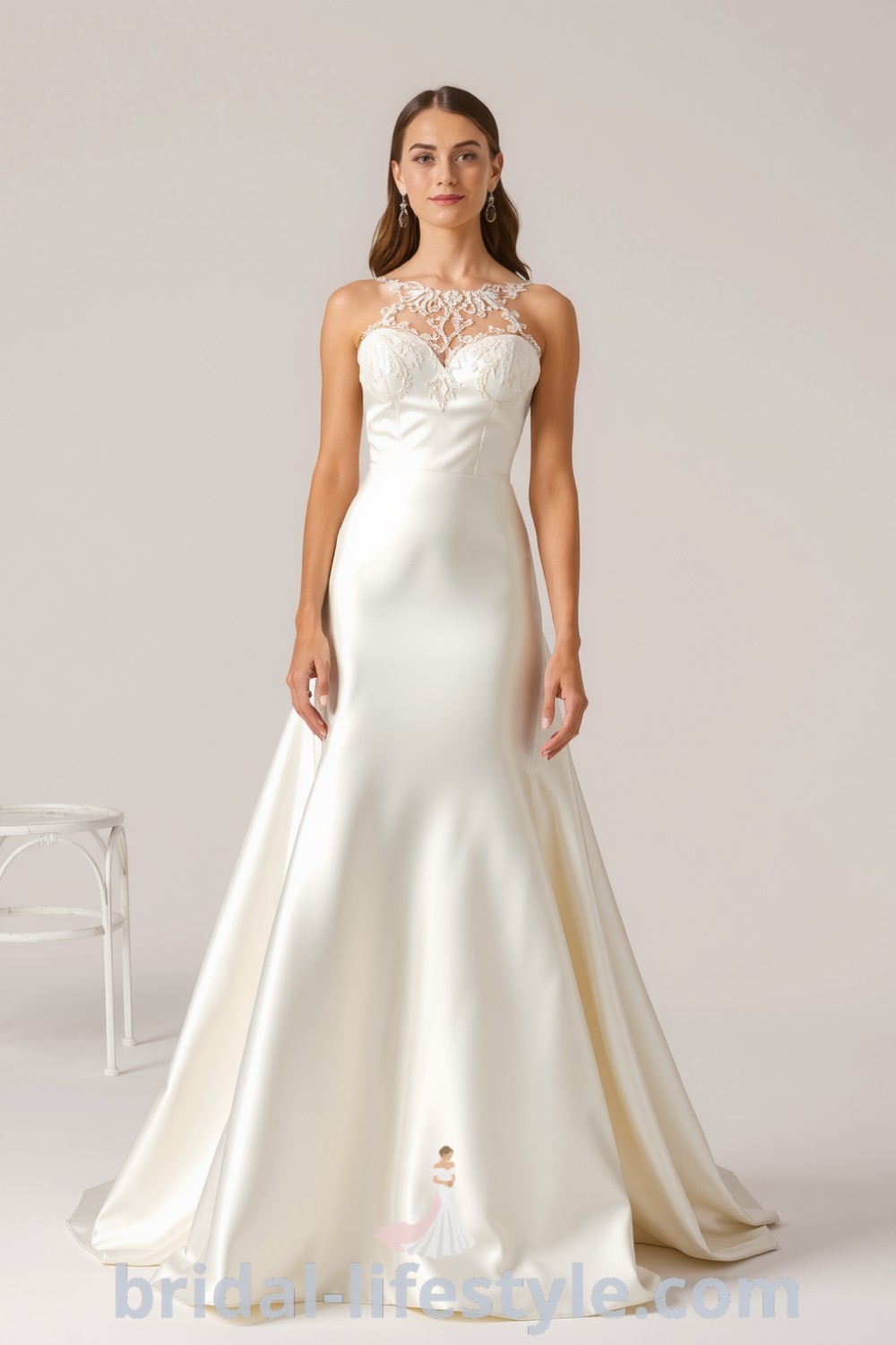 Fit and flare satin wedding dress with delicate lace detailing at the neckline and hem, creating an elegant silhouette perfect for dreamy brides. bridal-lifestyle.com