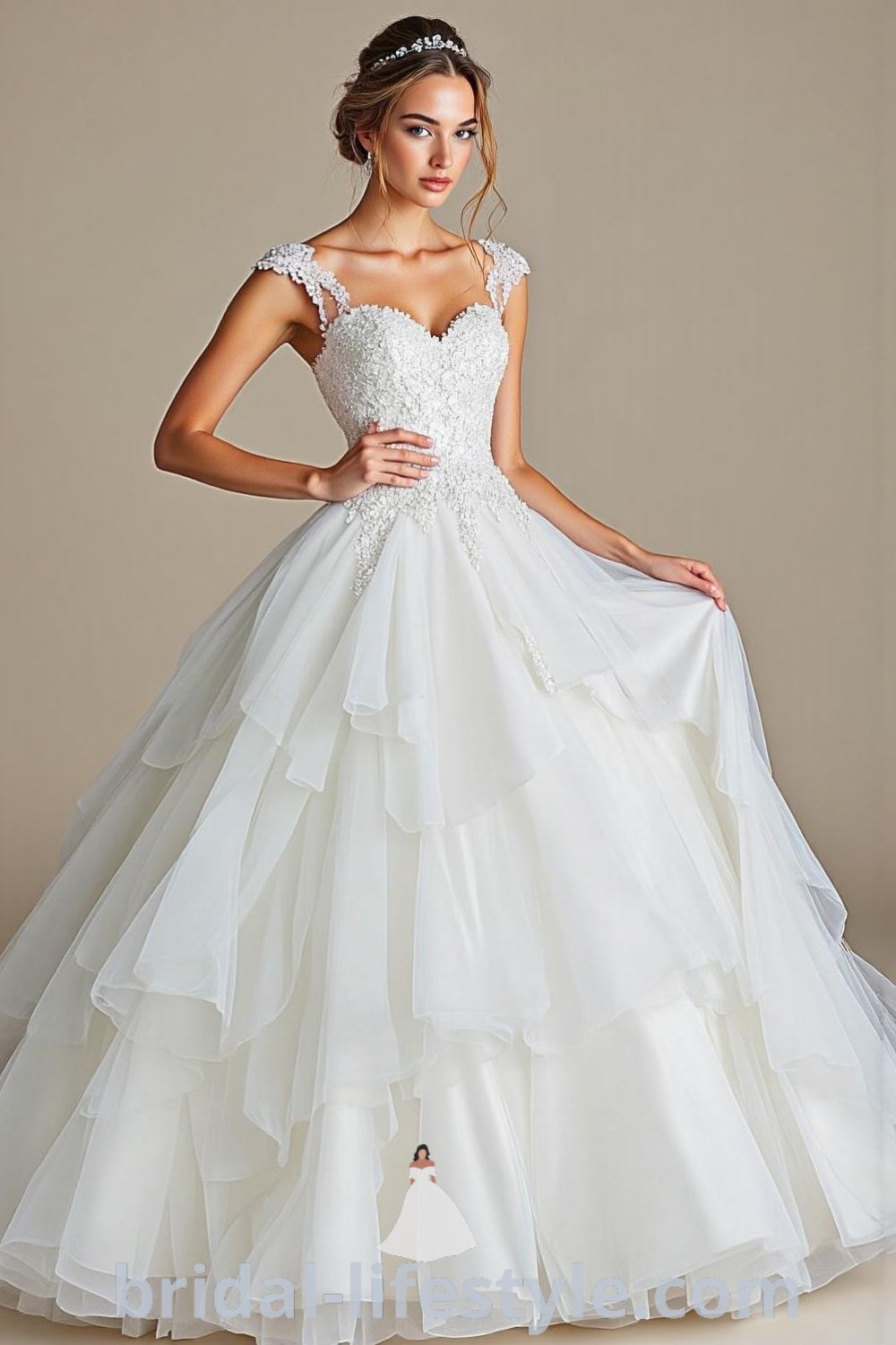 Elegant Princess wedding dress with a full tulle skirt, lace appliqués, beadwork, sweetheart neckline, and delicate cap sleeves, perfect for a grand celebration. bridal-lifestyle.com