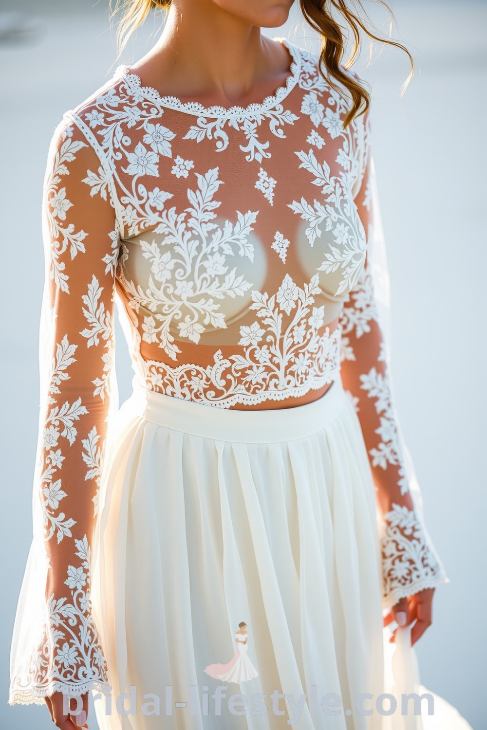 Boho two-piece wedding dress with lace top, long sleeves, and flowing chiffon skirt, showcasing a romantic silhouette. bridal-lifestyle.com